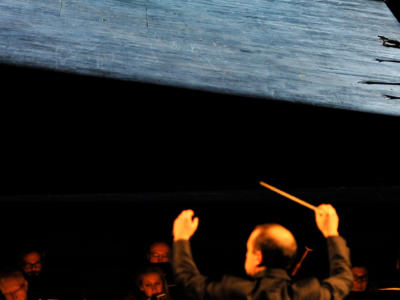 Man conducting orchestra at the Magic Flute