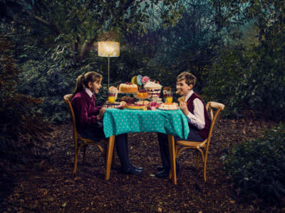 Hansel and Gretel | Two children eating cake at the table