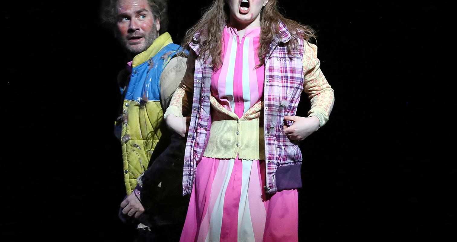 women in pink singing out to the audience