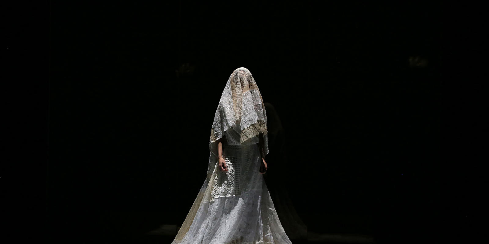 Sarah Tynan on stage in a wedding dress