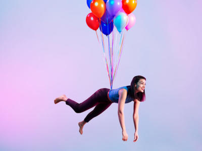 women flying with balloons