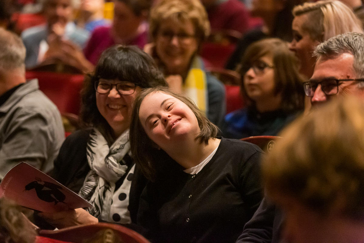 two audience members smiling