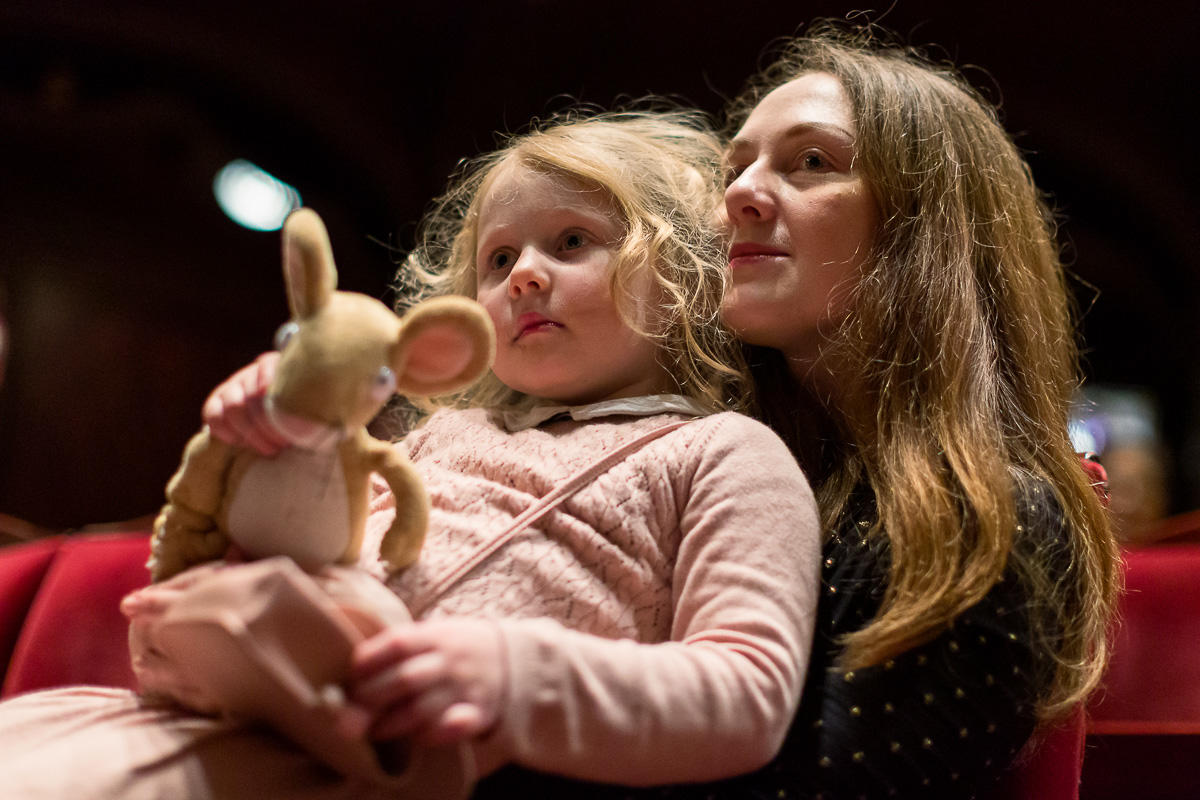women with a child in her arms, holding a toy rabbit