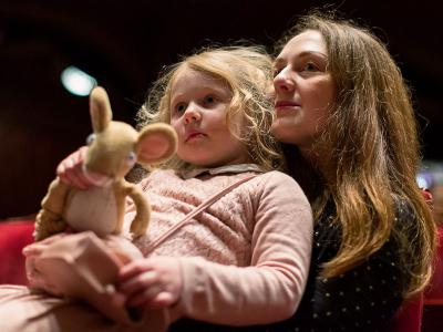 women with a child in her arms, holding a toy rabbit