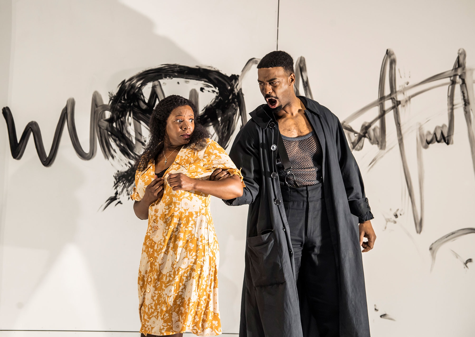 Wurm grips Luisa's arm, as she fearfully looks back at him