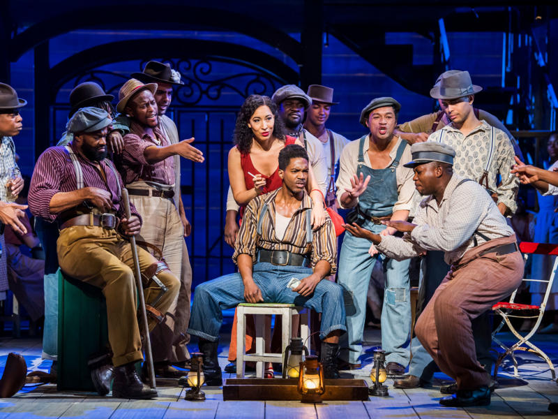 cast on stage gathered around porgy and bess