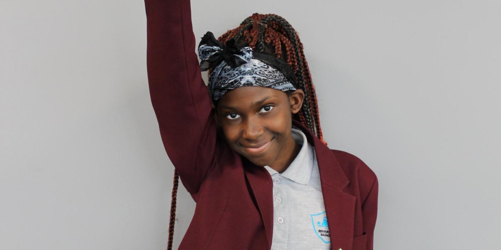 schoolgirl with hand up in the air