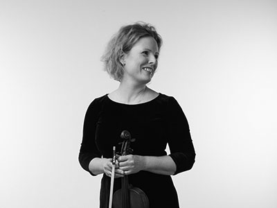 Sophia Durrant holding a violin and looking to the left