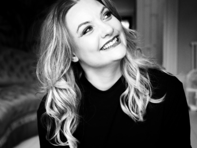 Black and white headshot of Jennifer Davis smiling upwards.