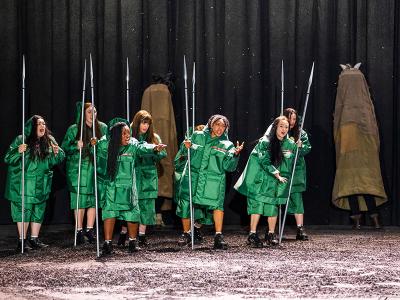The Valkyrie: Four women in green on stage