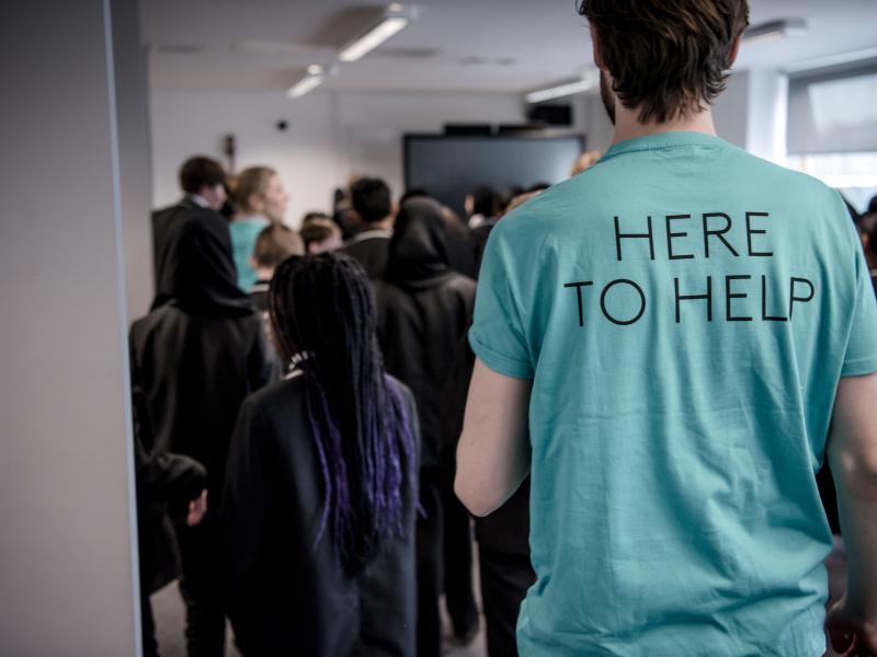 An ENO staff member wears a shirt that says 'Here to help'