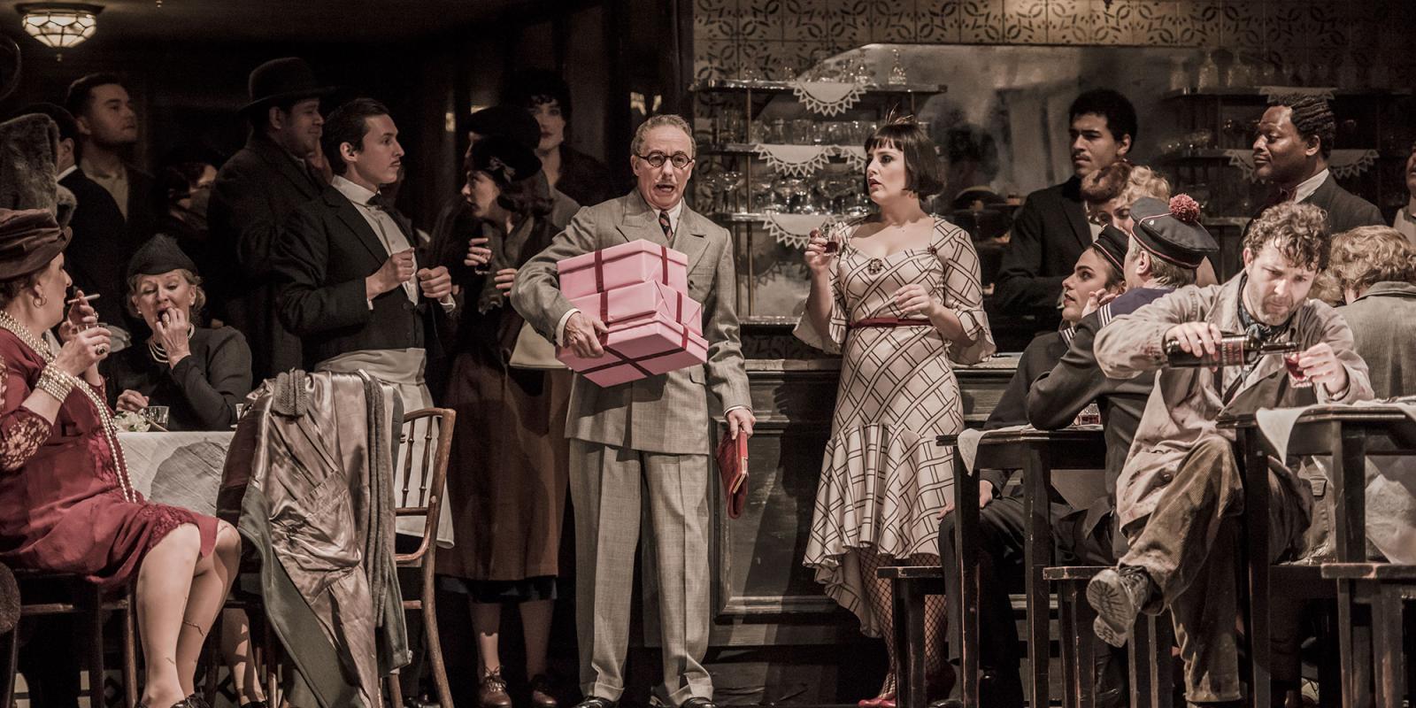 ENO2122 La bohème: Simon Butteriss as Benoit/Alcindoro, Louise Alder as Musetta, Charles Rice as Marcello © Genevieve-Girling