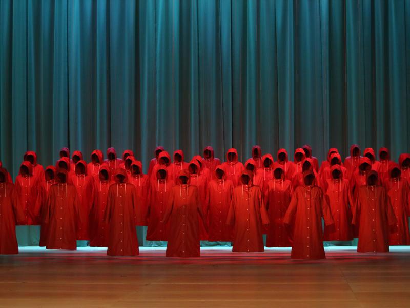 Performers in red coats for production The Handmaid's Tale