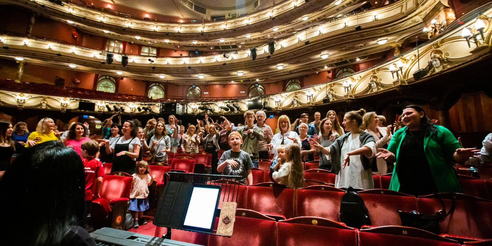 Group in workshop in the London Coliseum auditorium