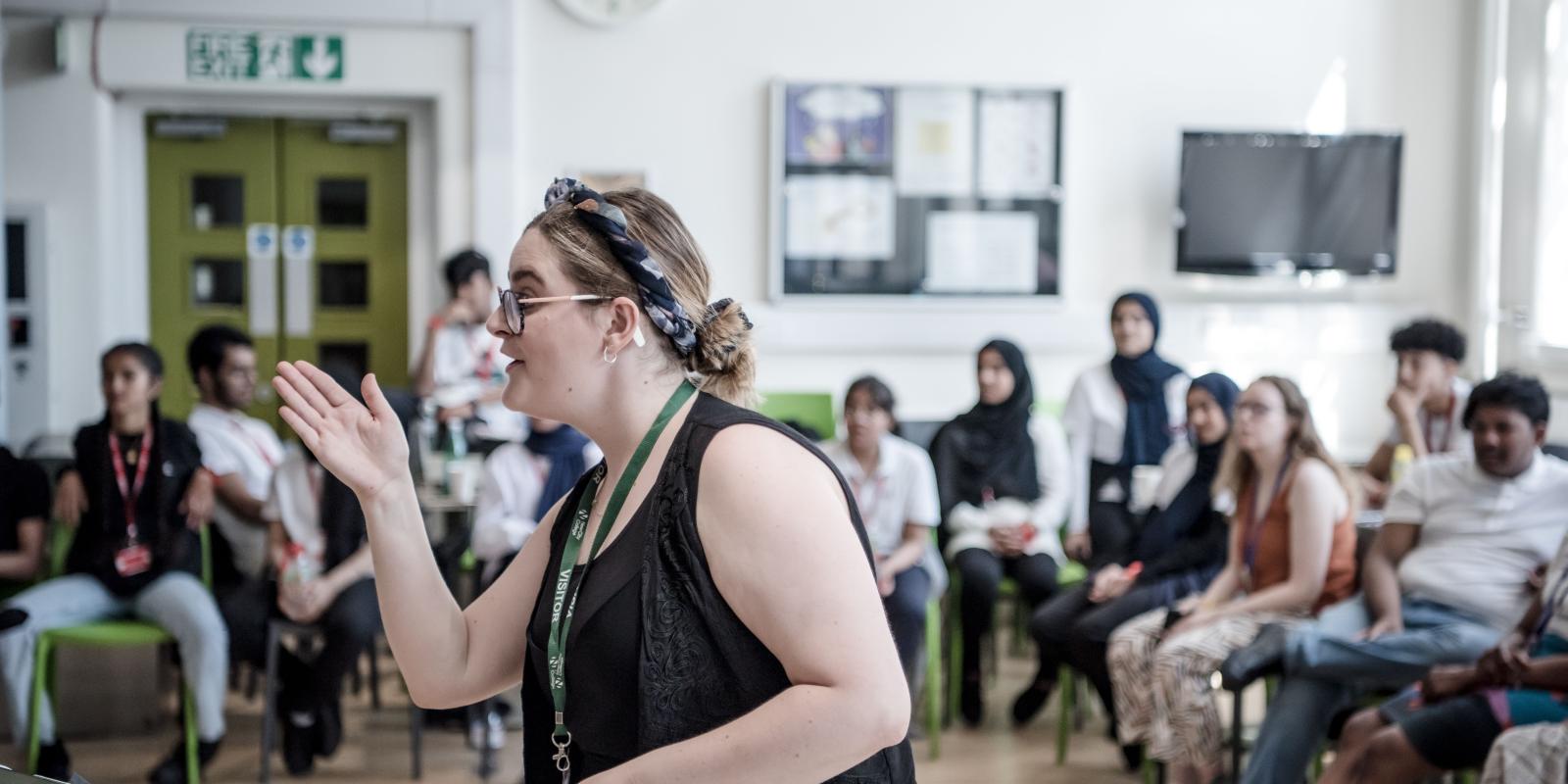 Woman giving instructions to a of students