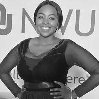 Black and white image of Segomotso Shupinyaneng standing with hands on her hips