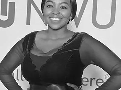 Black and white image of Segomotso Shupinyaneng standing with hands on her hips
