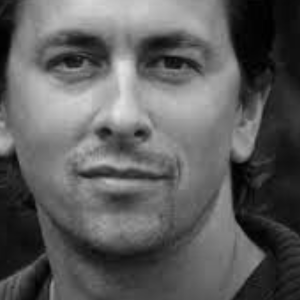 Black and white headshot of Jon Morrell looking to camera.