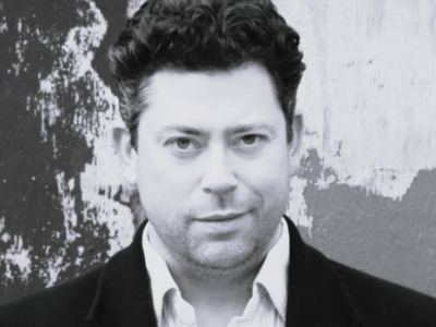 Black and white headshot of David Stout looking to camera