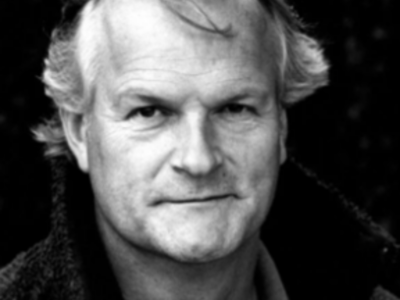 Black and white headshot of Clive Mantle facing the camera