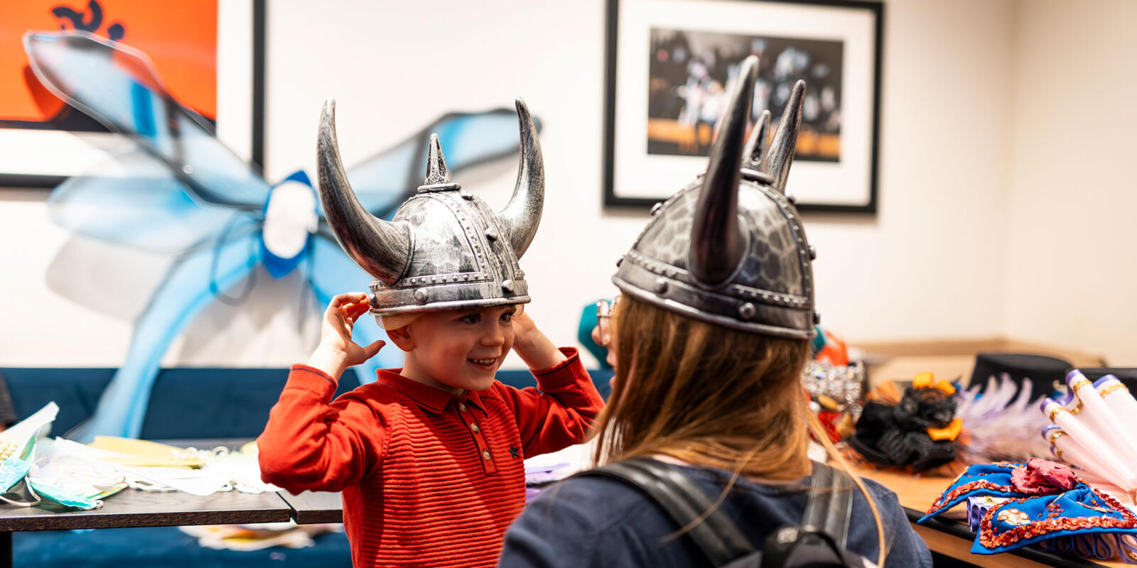Young child trying on Viking helmet in the costume dress up area prior to the Relaxed performance of ENO's Iolanthe---Wednesday 25 October 2023 © Lloyd Winters
