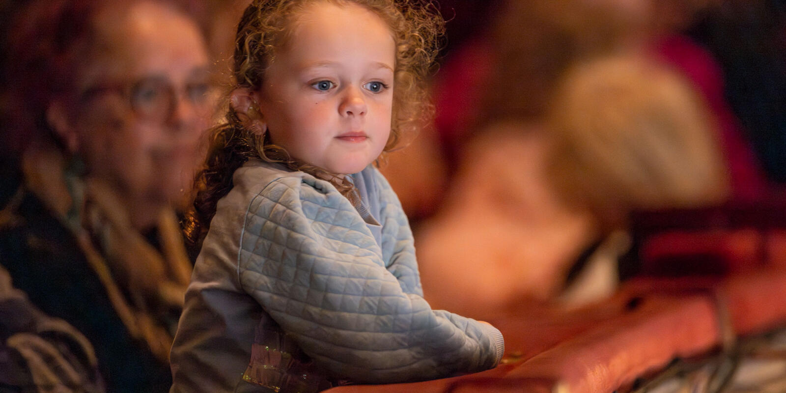 Young child looking around in the auditorium during the Relaxed performance of ENO's Iolanthe---Wednesday 25 October 2023 © Lloyd Winters