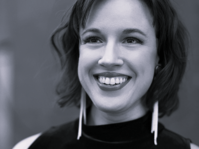 Black and white headshot of Rainelle Krause smiling